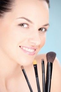 Lady holding brushes/freedigitalphotos