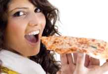 Girl eating pizza/freedigitalphotos