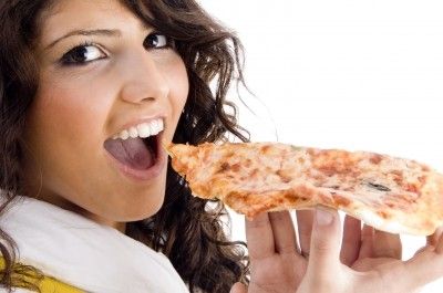 Girl eating pizza/freedigitalphotos