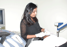 Dr Sirisha Singh examining the skin of a patient