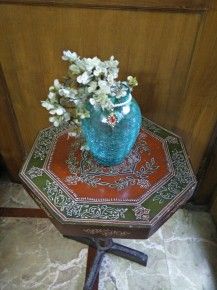 A beautiful blue vase with bead work on neck