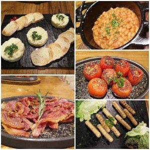 Eggs, bacon, baked beans, tomatoes and sausages at Uzzuri