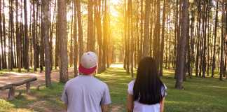 Happy couple embracing at sunset in the nature