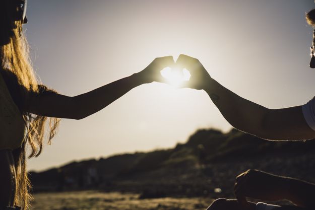 Couple forming heart