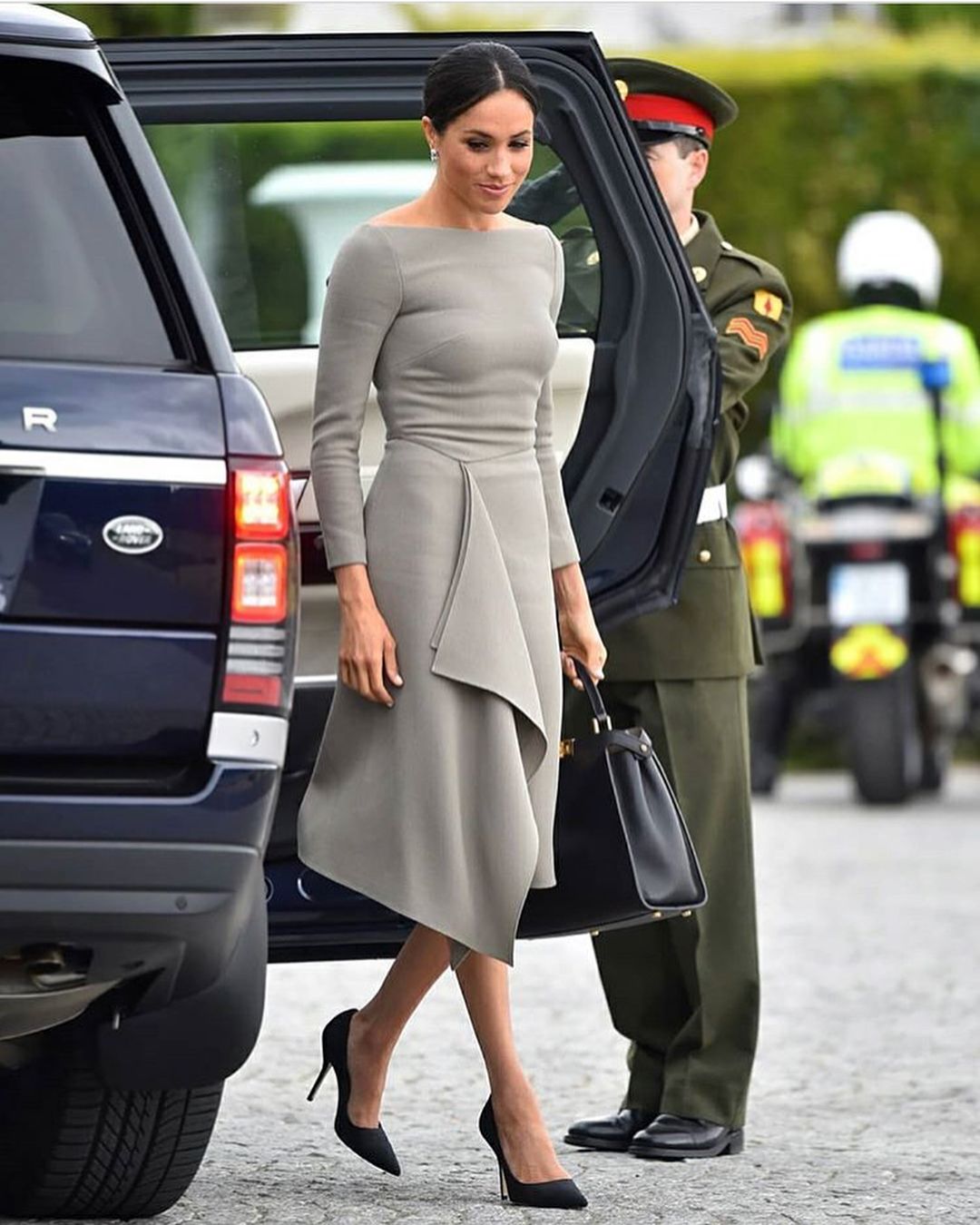 The Duchess wore a stylish grey dress with a bateau neckline and draping detail at an meeting